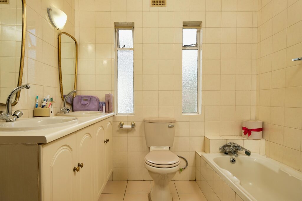Luxurious traditional bathroom featuring a double sink vanity, bathtub, and classic fixtures.